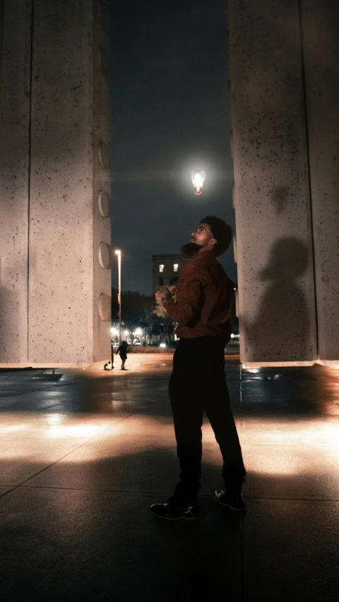 a person stands in the middle of a building with columns