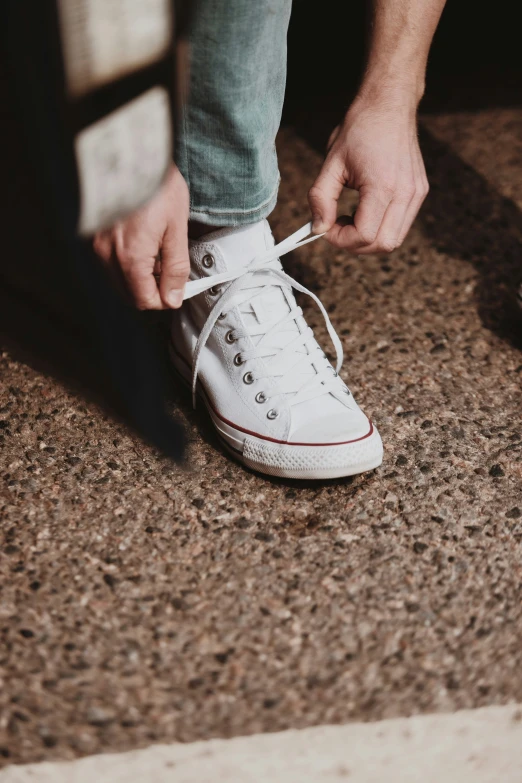 a close up of someone tying a shoe