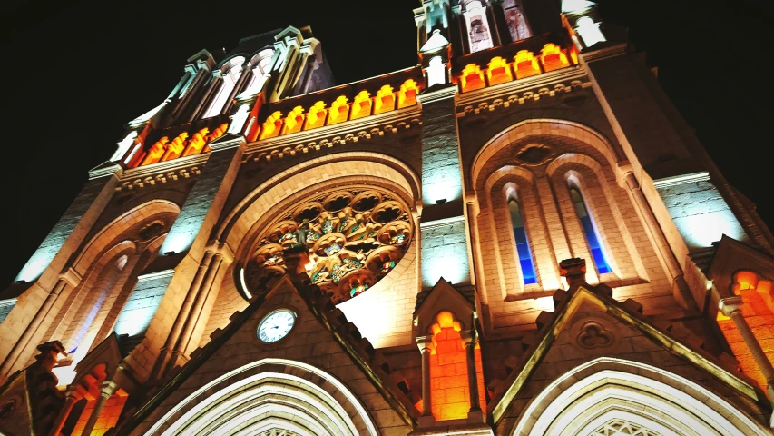 a cathedral with colorful lights on its steeple