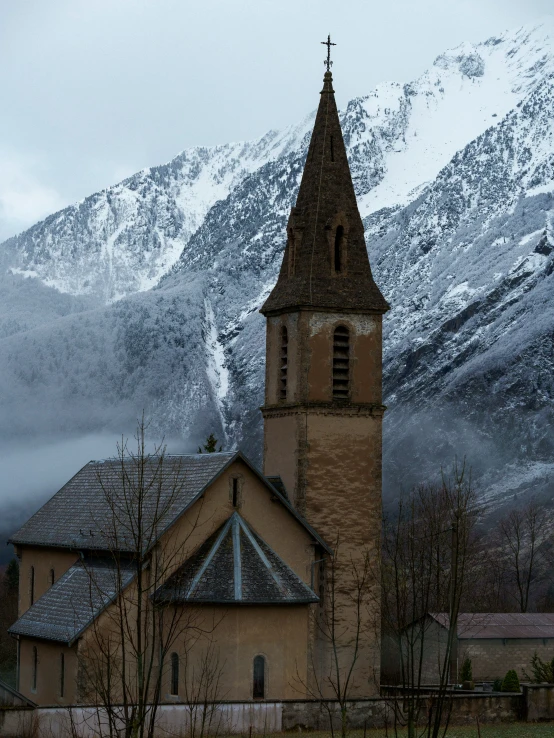 a large church building is in the middle of mountains