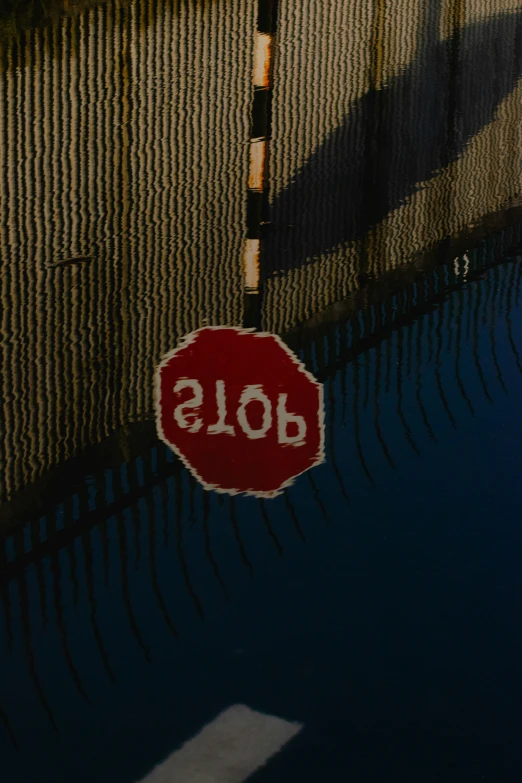 a stop sign is reflected on a window pane