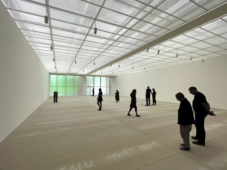 a large open room with several people standing inside
