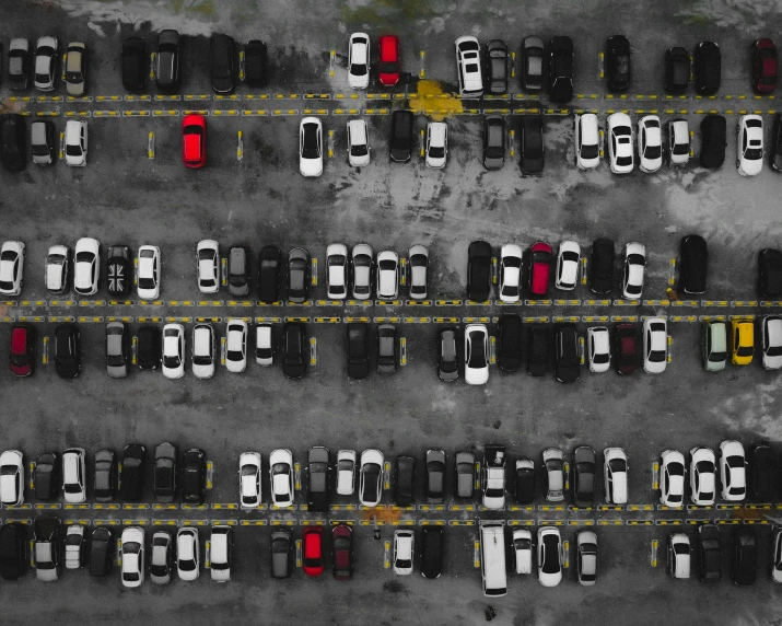 an overhead view of multiple rows of parked cars