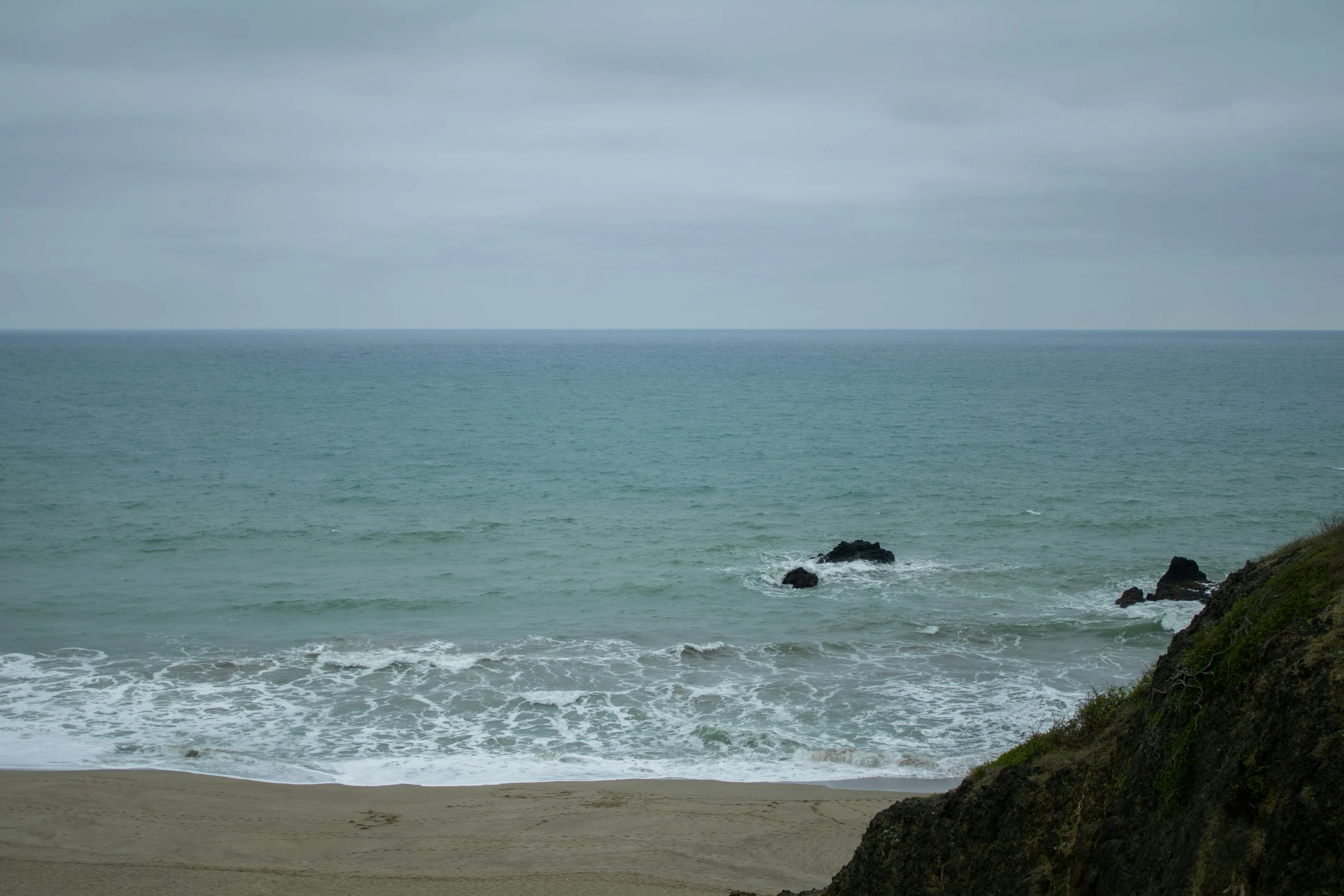 a large body of water sitting next to a beach