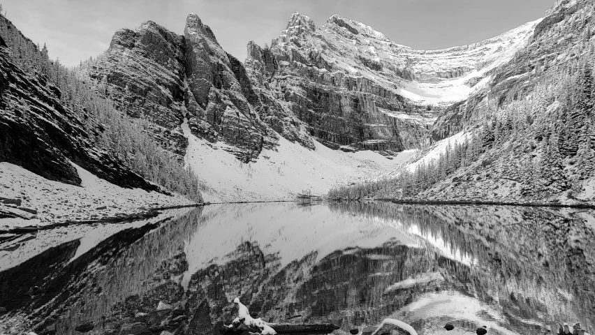 a mountain with many snow covered mountains and one body of water