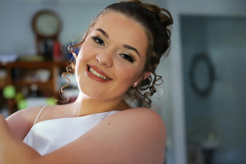 the woman is smiling and posing in her wedding gown