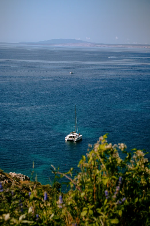 a boat floating on a lake in the middle of a large body of water