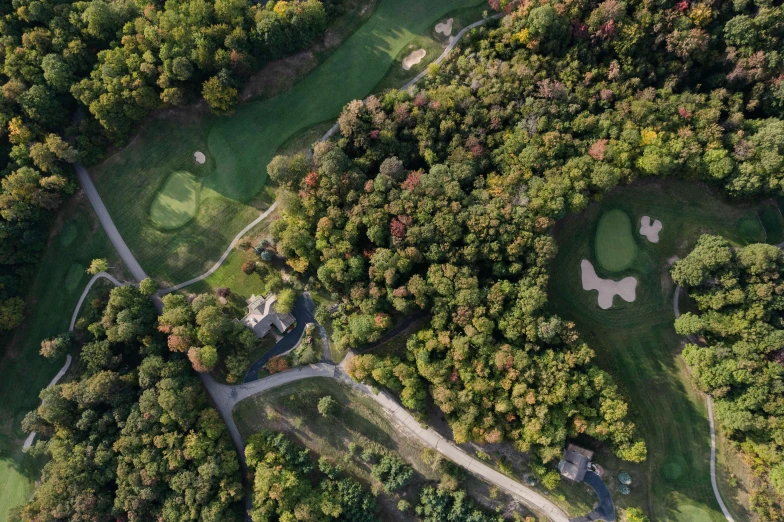 the aerial view of a golf course and several putting greens