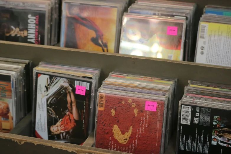 many cds sit on display on the shelf