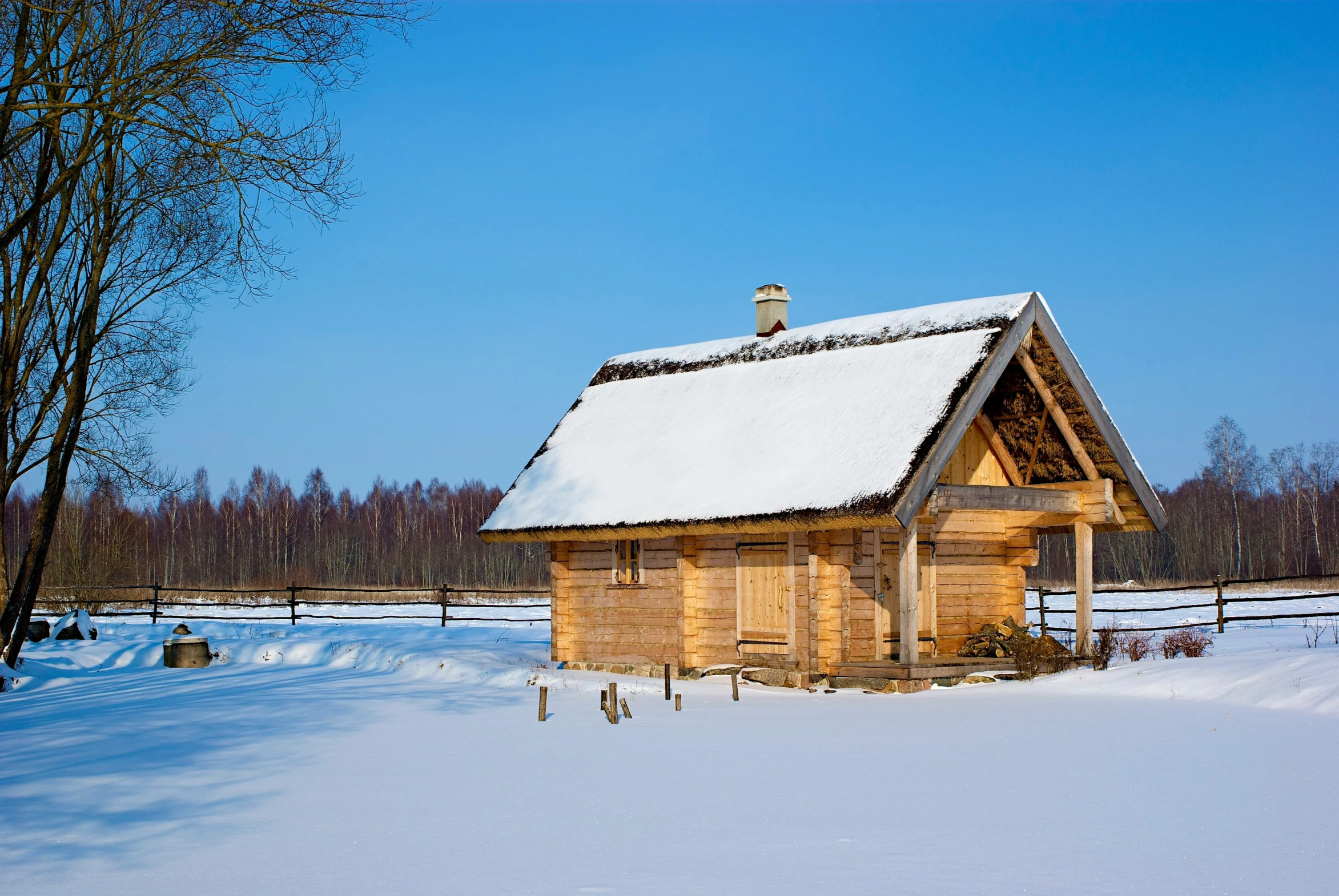 a log cabin with a roof covered in snow