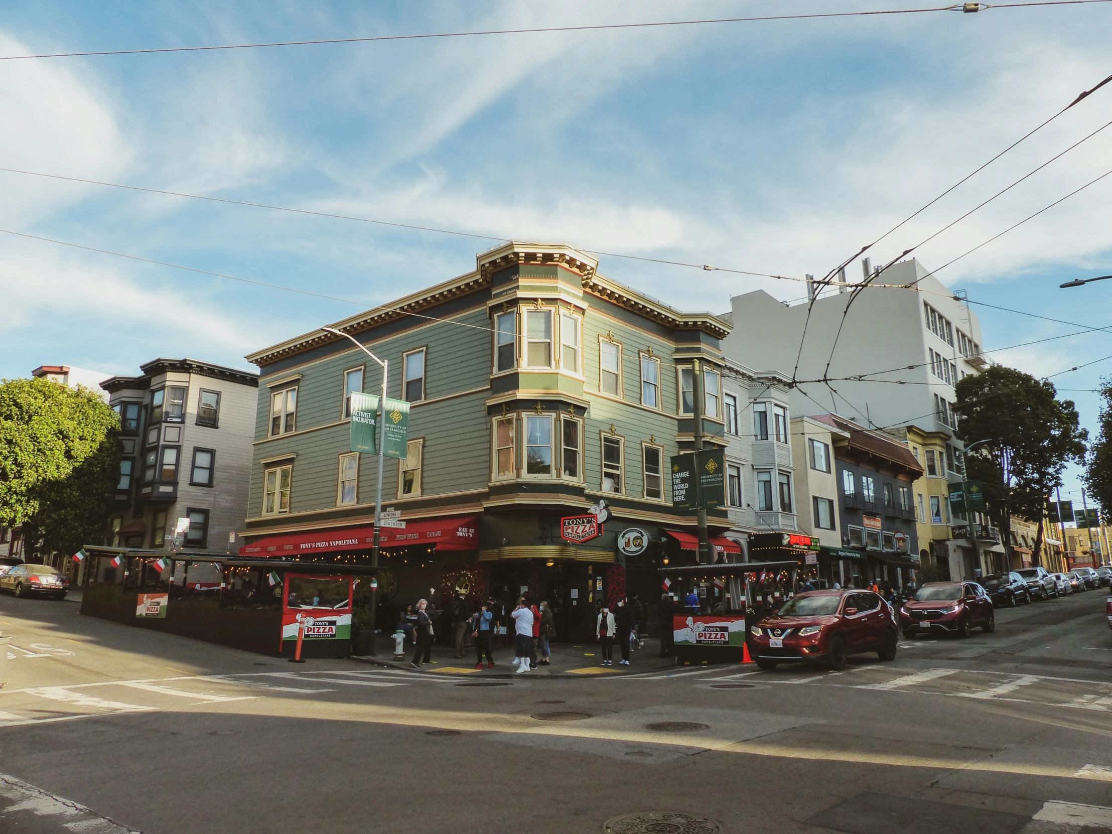 an intersection shows several stores on the corner