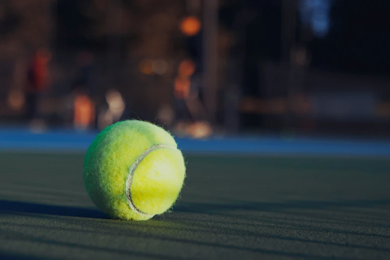 a tennis ball laying on the court