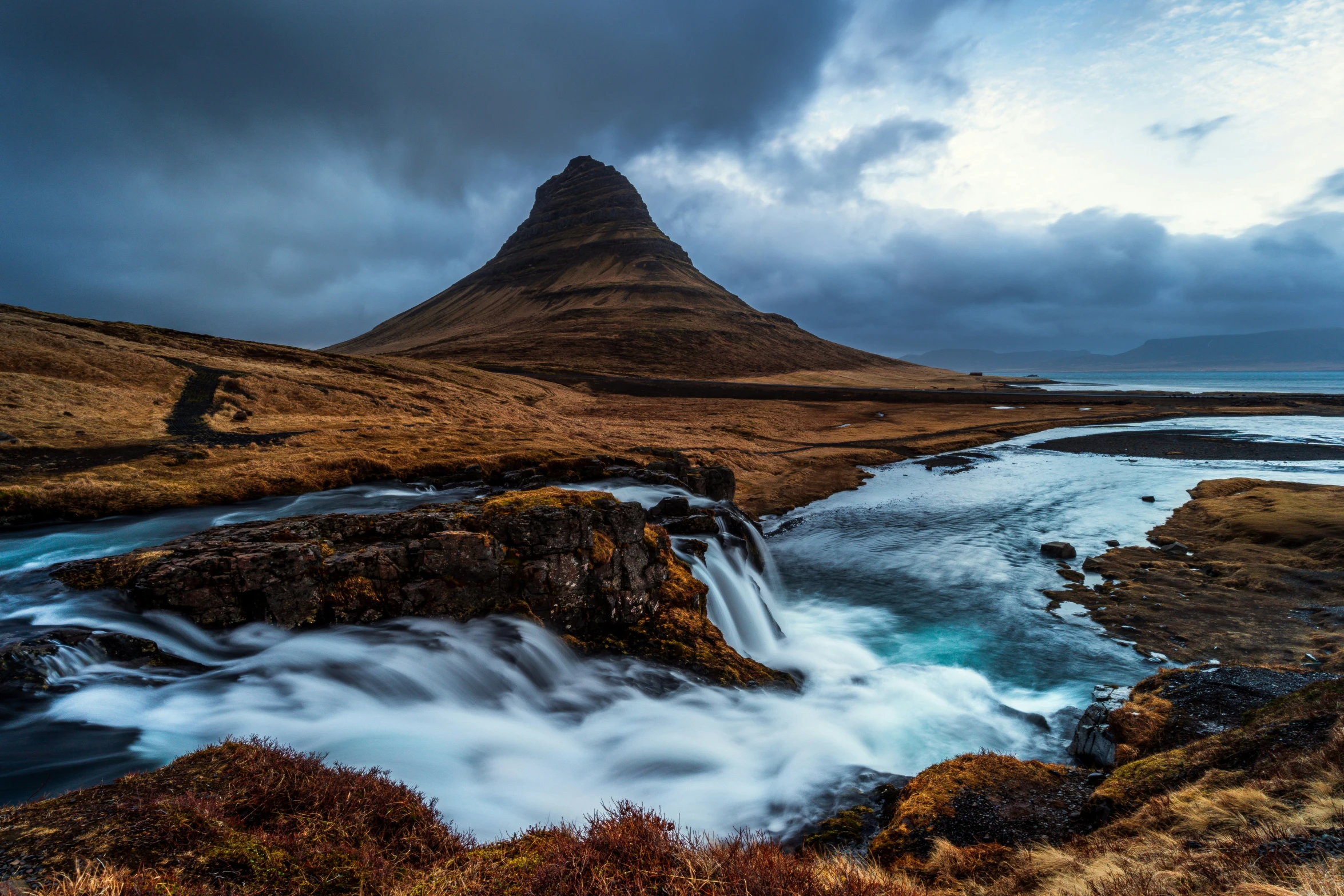 the mountain is very close to the waterfall