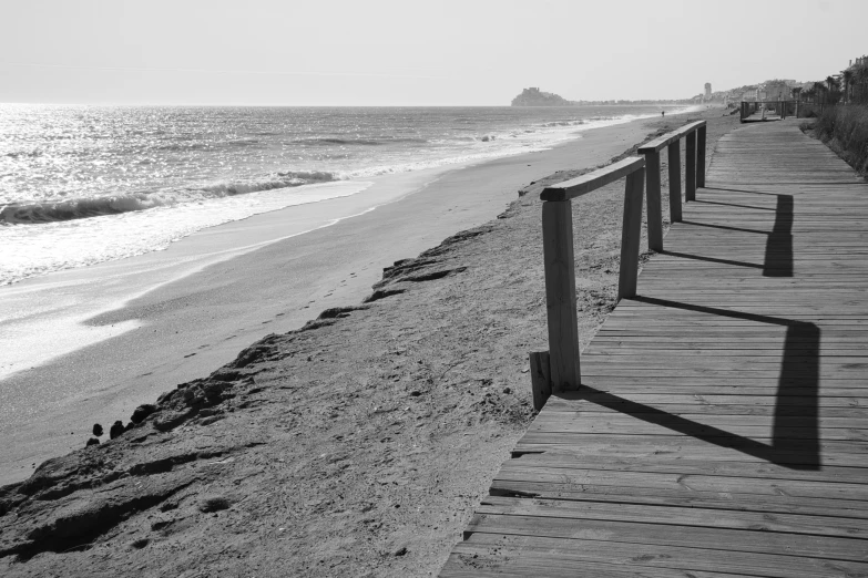 a walkway at the beach is stretching out into the ocean