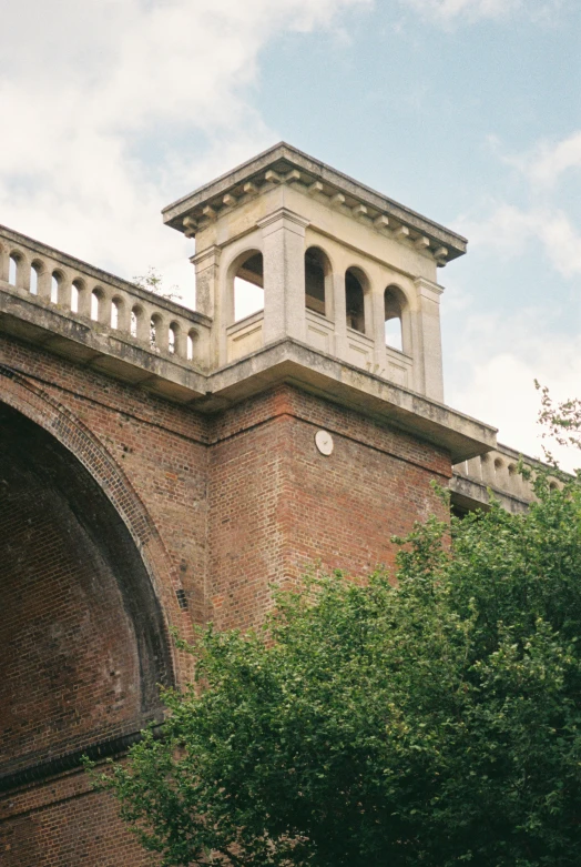 there is a tower in the top of an old brick building