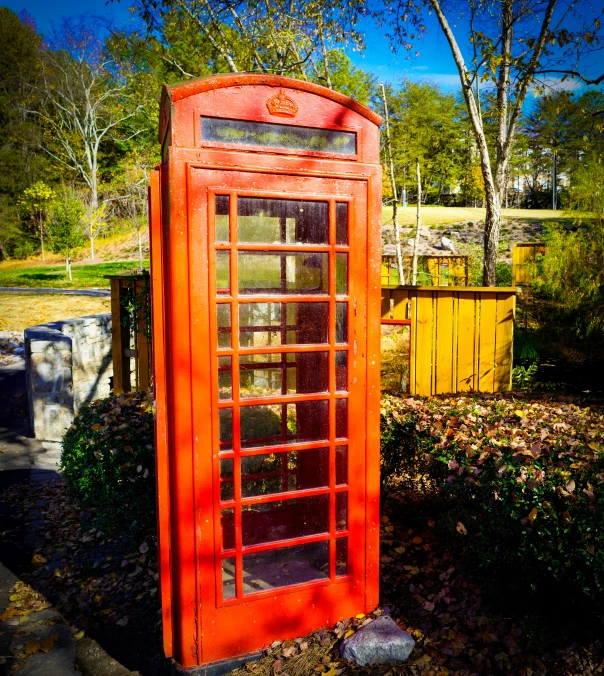 a phone booth is displayed in a grassy area