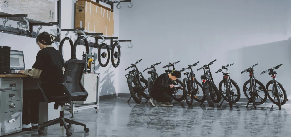 some bikes are parked on a shelf by a wall