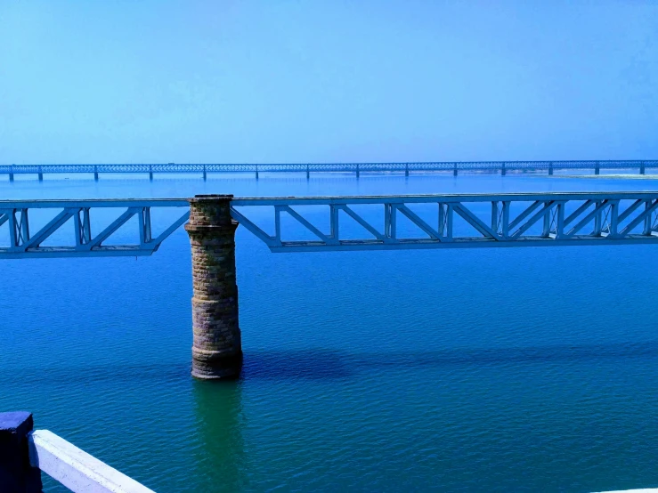 a large bridge is shown spanning the width of water