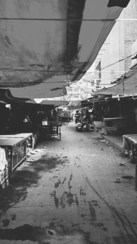 an old street with some tables in it