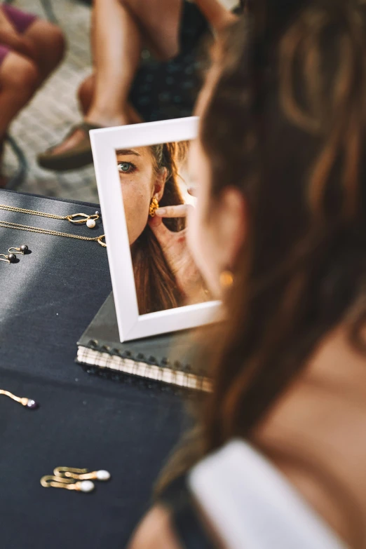 a person holding a po with a mirror on top of it