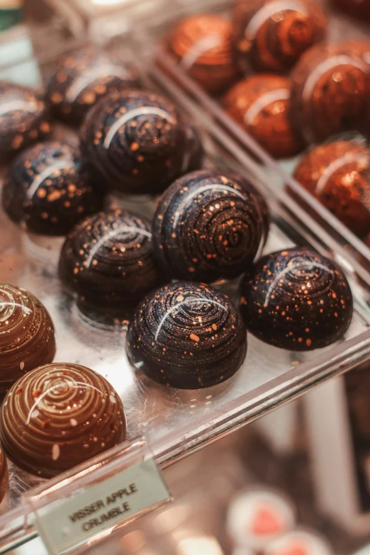 chocolate truffles sit on display in the shop window