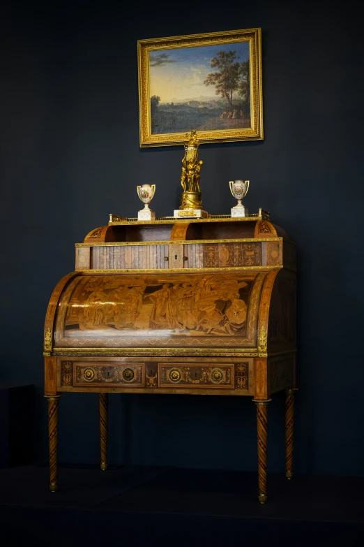 a table with an intricate looking surface and a painting on it