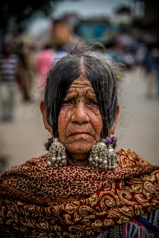 the woman with earrings is looking into the camera