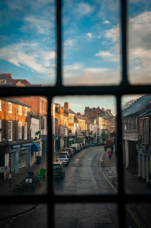 the view from a window overlooking an empty street