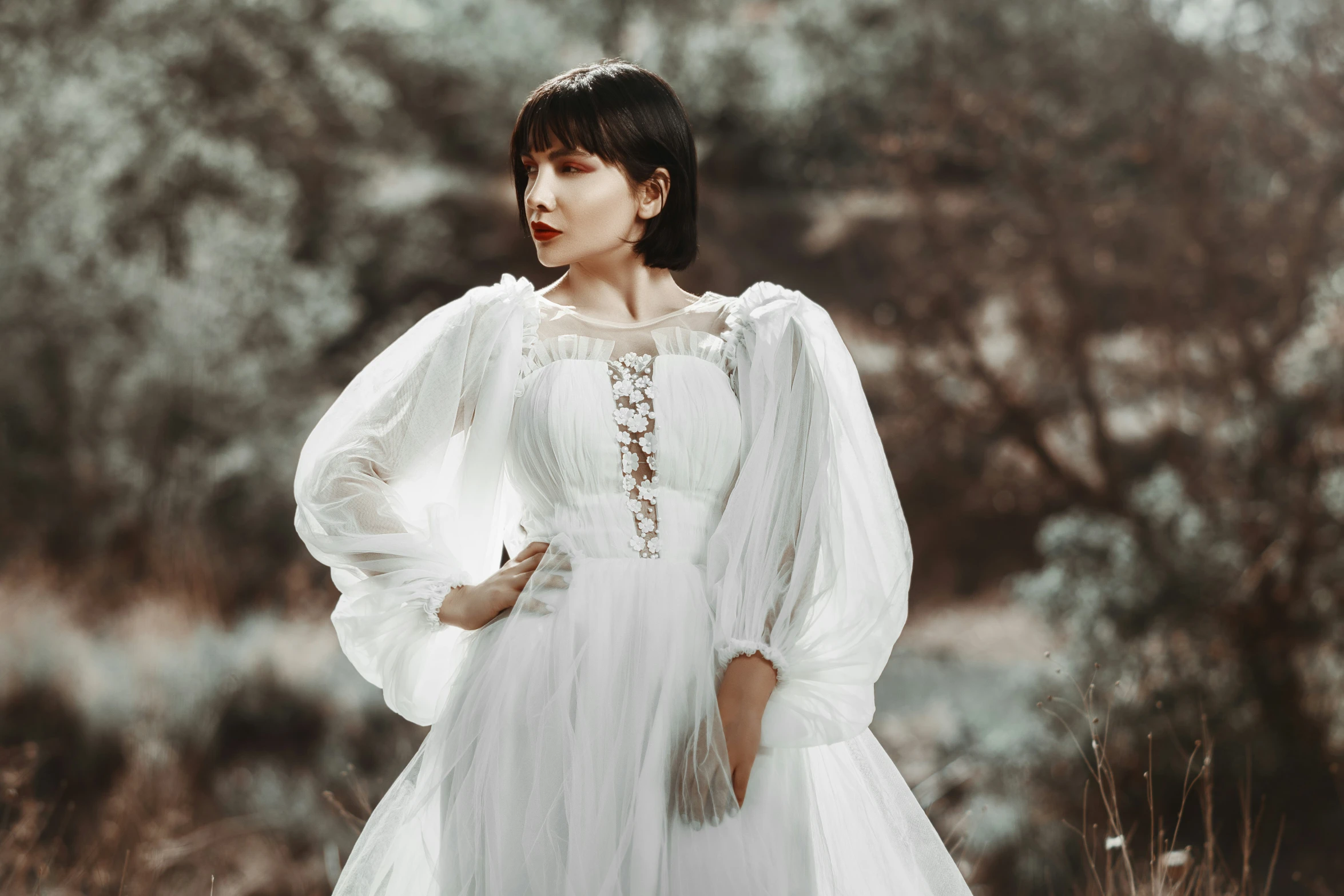 a woman in a white dress is posing for the camera