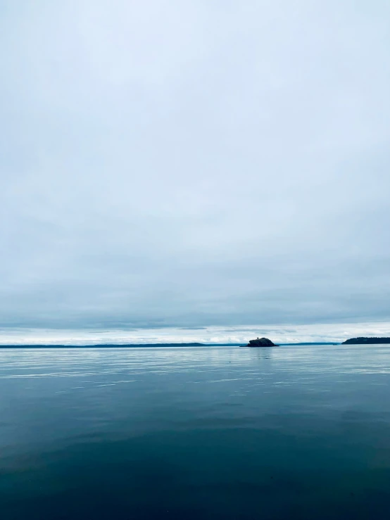 a big body of water sitting under a cloudy sky