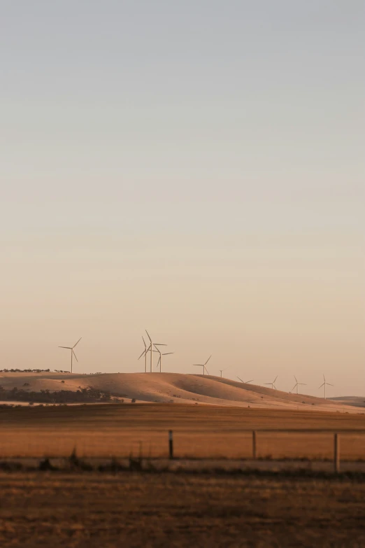 multiple wind mills on a large flat plain