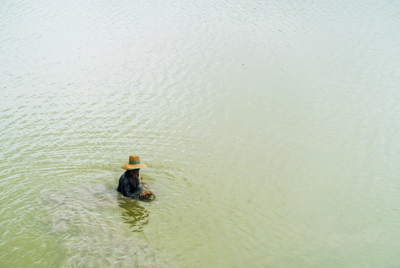 a person is in the water with a umbrella