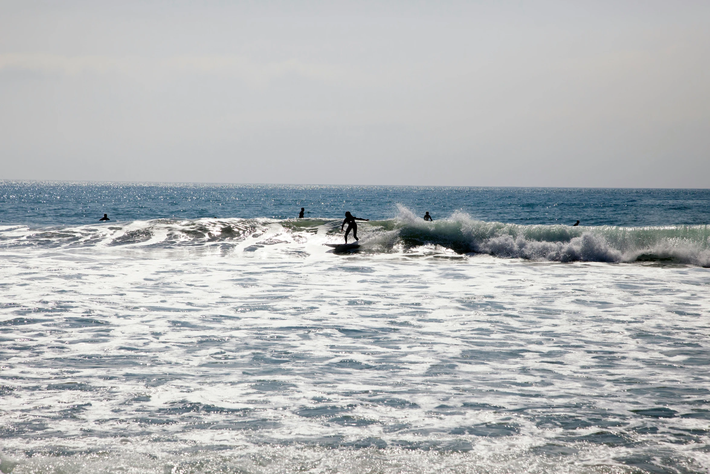 two people in the ocean riding surfboards