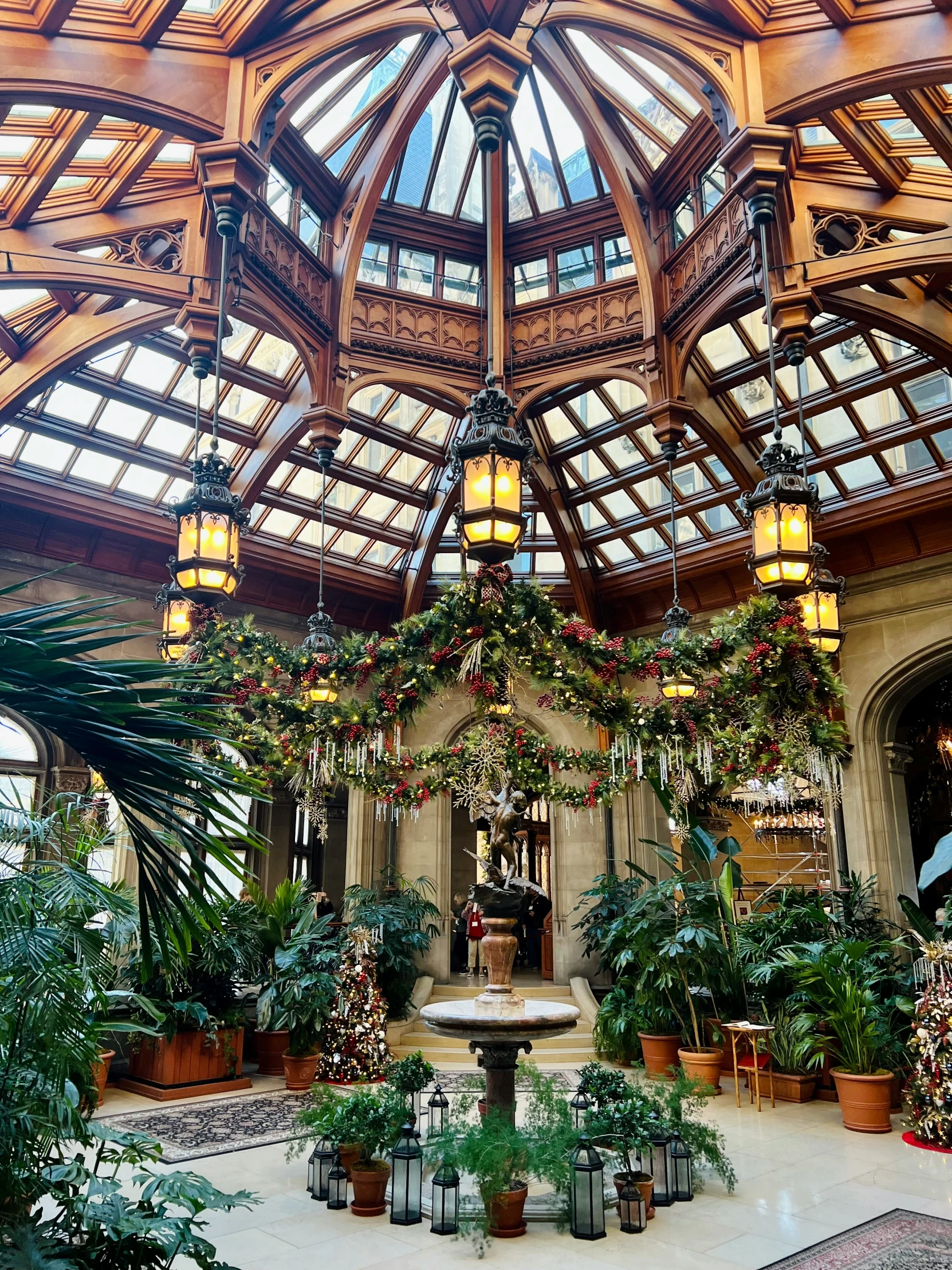 inside the greenhouse at kew gardens, where a waiter is preparing for an event