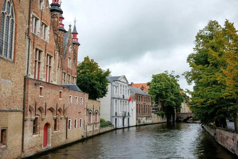 a street with canals in the middle and houses on both sides