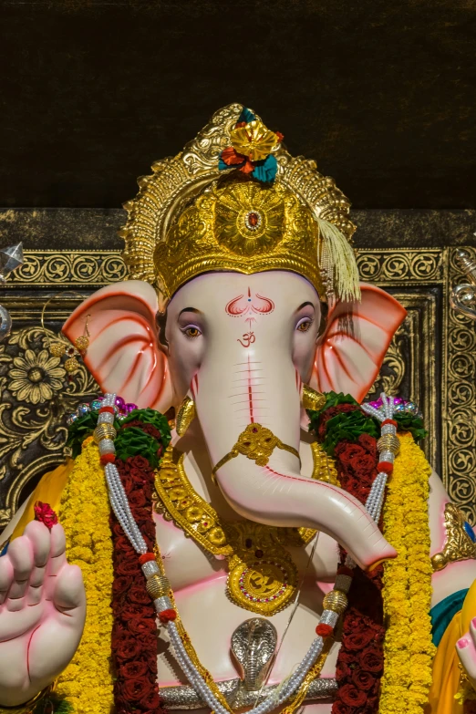 an elephant standing in a shrine with its trunk up