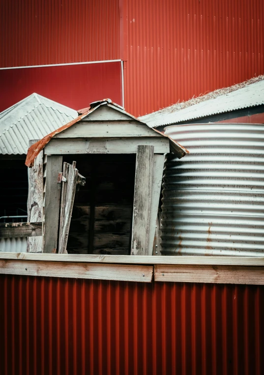 the building is painted red and tin cans have a small window