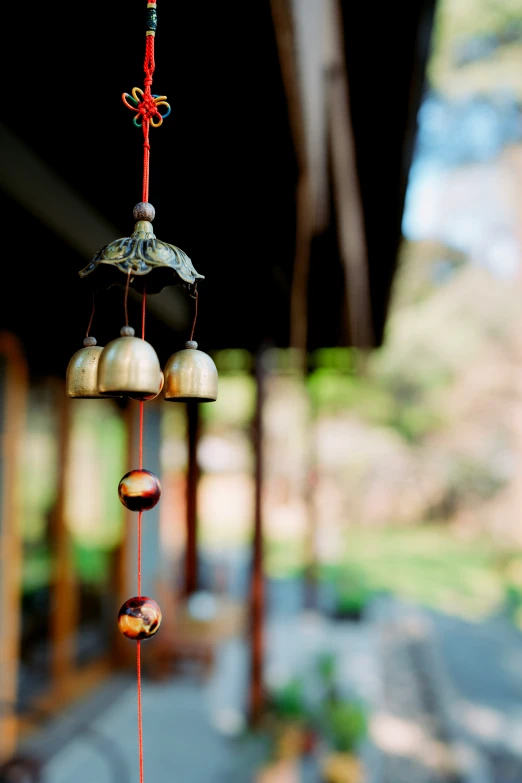 an elaborate bird feeder with bells in various sizes