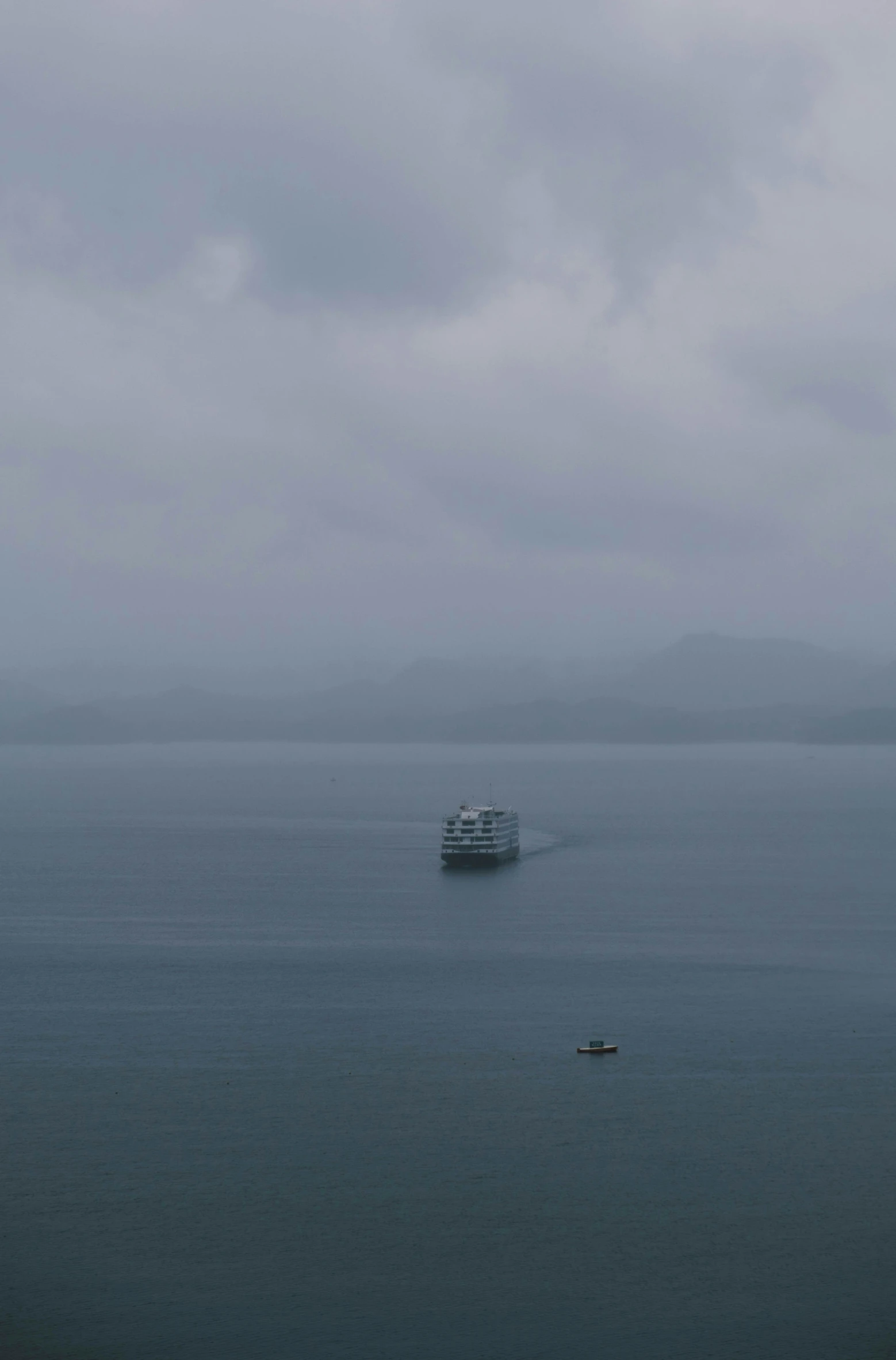 a ferry boat out on the sea in the distance