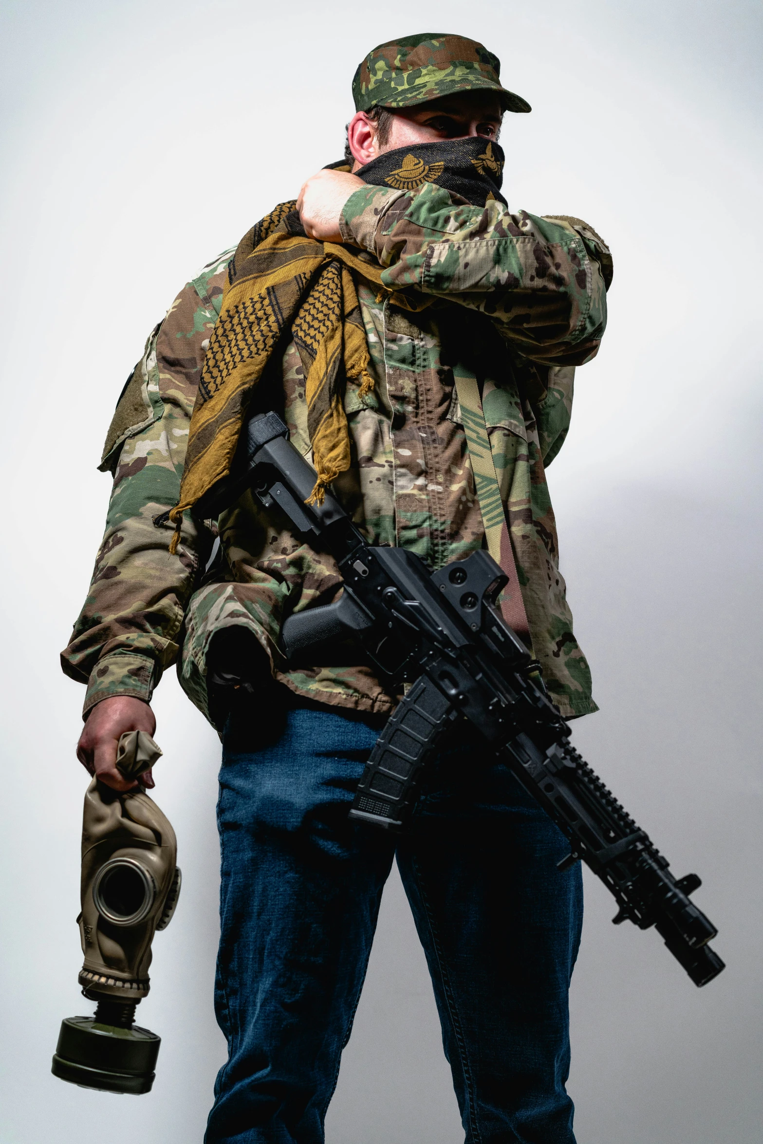 a man holding a rifle and camouflage vest