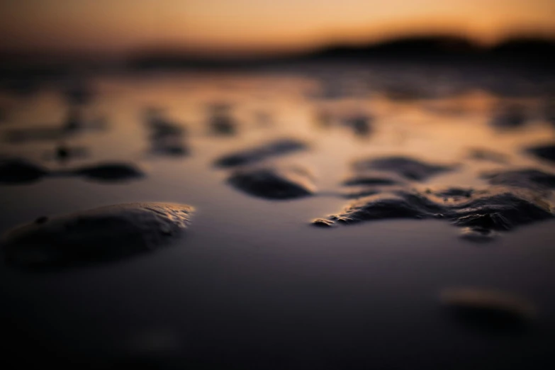 a black and white picture of sand and water