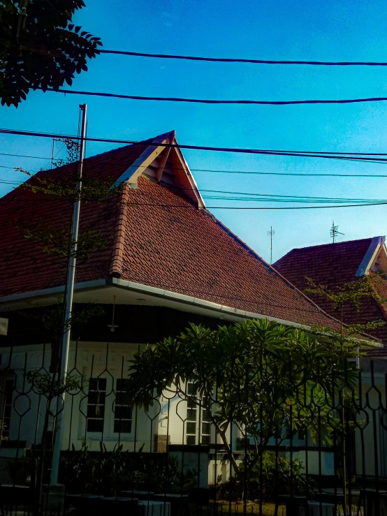 two houses on the street with wires in front of them