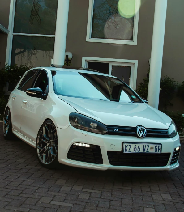 a white car parked in front of a house