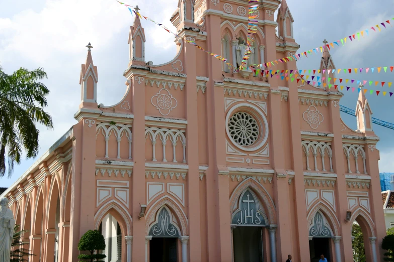 a pink church with flags and decorations on it
