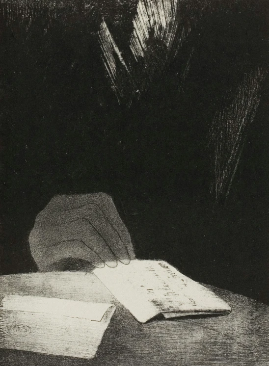 a wooden table topped with a box and paper