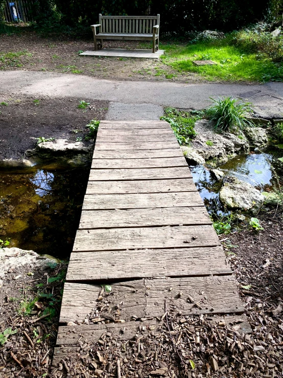 a pier next to the water and a wooden bench