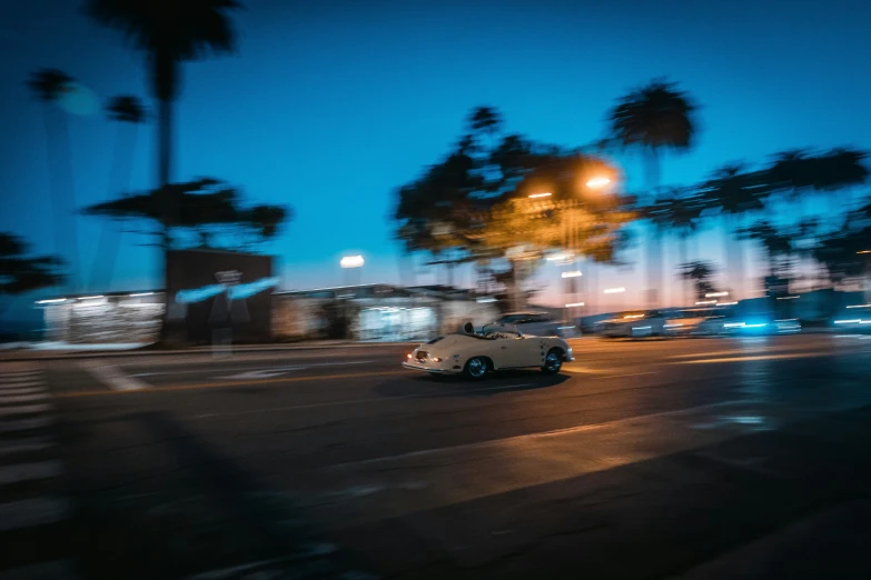 a car driving down the street at night