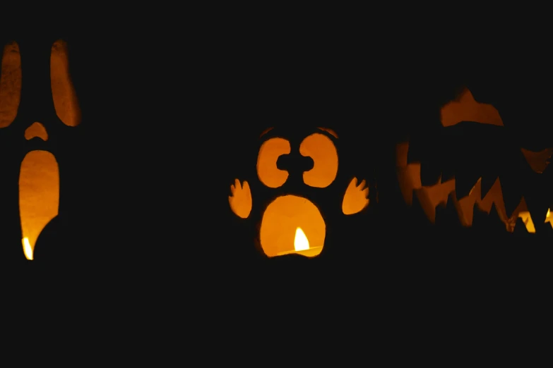 a dark background has several halloween shaped decorations