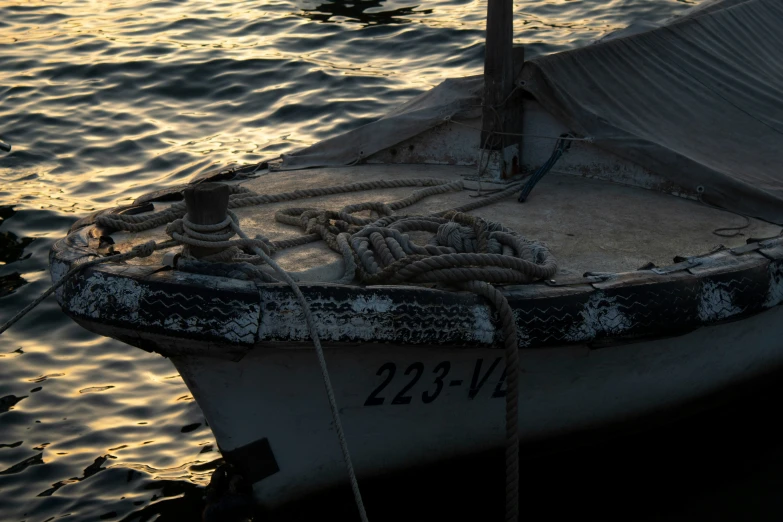 small boat in the middle of water at sunset