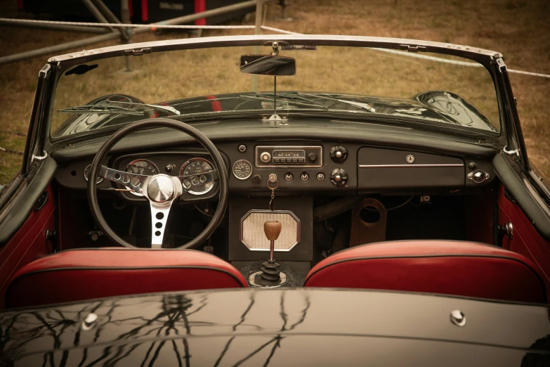 an old time looking car with dashboard, steering wheel and panel